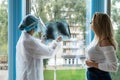 Female doctor talking patient about analyzing x-ray chest scan Royalty Free Stock Photo