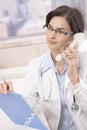Female doctor talking on phone Royalty Free Stock Photo