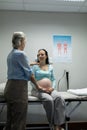 Female doctor talking with pregnant woman in examination room Royalty Free Stock Photo