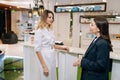 Female doctor talking with young woman patient about medical examination or test results. Lady standing with physician Royalty Free Stock Photo