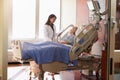 Female Doctor Talks To Senior Female Patient In Hospital Bed Royalty Free Stock Photo