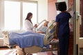 Female Doctor Talks To Senior Female Patient In Hospital Bed Royalty Free Stock Photo