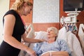 Female Doctor Talks To Senior Female Patient In Hospital Bed Royalty Free Stock Photo