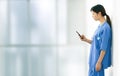 Female doctor texting during a break from work shifts Royalty Free Stock Photo