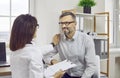 Female doctor therapist in white coat talking to male patient Royalty Free Stock Photo