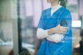 Female doctor in uniform holding a stethoscope waiting to examine a patient. A female doctor holds a stethoscope to prepare for