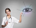 Female doctor in uniform touch painted human eye Royalty Free Stock Photo