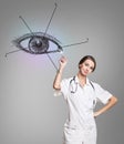 Female doctor in uniform touch painted human eye Royalty Free Stock Photo