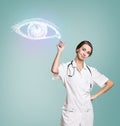 Female doctor in uniform touch painted human eye Royalty Free Stock Photo