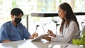 A female doctor uses a digital tablet to show her patient an x-ray image Royalty Free Stock Photo