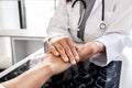 The female doctor uses a friendly hand to hold the hand of the patient to give confidence after the x-ray and advise on health Royalty Free Stock Photo