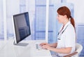 Female Doctor Using Computer At Desk In Clinic Royalty Free Stock Photo