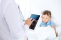 Female doctor using a digital tablet, close-up of hands. Health care concept or children`s therapy Royalty Free Stock Photo