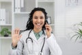 Female doctor using headset during virtual consultation Royalty Free Stock Photo