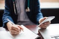 Female doctor using mobile phone