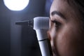 Female doctor using otoscope for examination, side view Royalty Free Stock Photo