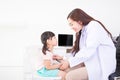 The female doctor is using a stethoscope. The doctor examines the flu girl in a white examination room with a laptop Royalty Free Stock Photo