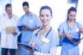 Female doctor using tablet and smiling at camera Royalty Free Stock Photo