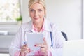 Female doctor using toucpad at the private clinic Royalty Free Stock Photo