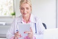 Female doctor using toucpad at the private clinic Royalty Free Stock Photo