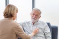 Female doctor visiting elderly man at home, Health visitor, and a senior man during home visit Royalty Free Stock Photo