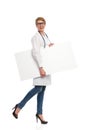 Female doctor walking with banner. Royalty Free Stock Photo