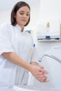 Female doctor washing hands