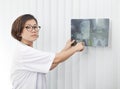 Female doctor watching on head skull x-ray film