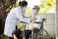 Female doctor wearing medical mask,using a stethoscope,listen to heart sounds and lungs,caring for old elderly,service and health Royalty Free Stock Photo