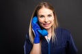 Female doctor wearing scrubs talking at blue telephone receiver Royalty Free Stock Photo