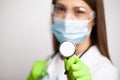 A female doctor in a white coat with a phonendoscope in her hands. Royalty Free Stock Photo