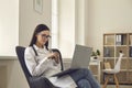 Female doctor consults online a patient through a video call while sitting in the office. Royalty Free Stock Photo