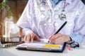 Female doctor working on desk with laptop computer and paperwork in the office. Royalty Free Stock Photo