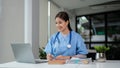 A female doctor is working on her medical research on her laptop in her office Royalty Free Stock Photo