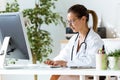 Female doctor working with laptop in the office. Royalty Free Stock Photo