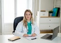 Female doctor working on medical consultation and treatment information on laptop at hospital office Royalty Free Stock Photo