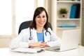 Female doctor working on medical expertise and searching information on laptop at hospital office Royalty Free Stock Photo