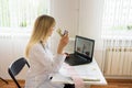 Female doctor working at office and smiling at camera, office interior.Online consultation, selection of treatment and Royalty Free Stock Photo