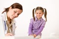 Female doctor write prescription for child