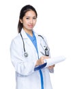 Female doctor write on report
