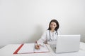Female doctor writing on binder at desk in clinic Royalty Free Stock Photo
