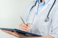 Female doctor writing medical information in notebook at hospital Royalty Free Stock Photo