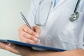 Female doctor writing medical information in notebook at hospital Royalty Free Stock Photo