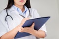 Female doctor writing medical information in notebook at hospital Royalty Free Stock Photo