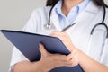 Female doctor writing medical information in notebook at hospital Royalty Free Stock Photo