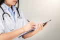 Female doctor writing medical information in notebook at hospital Royalty Free Stock Photo