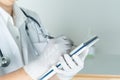 Female doctor writing medical information in notebook at hospital Royalty Free Stock Photo