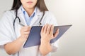 Female doctor writing medical information in notebook at hospital Royalty Free Stock Photo