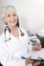 Female Doctor Writing Notes On Clipboard Royalty Free Stock Photo