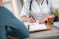 Female doctor writing prescription to her patient Royalty Free Stock Photo